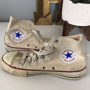 Cream colored high top Chuck Taylors